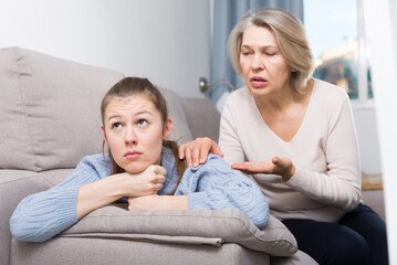 Mature woman trying to talk with her offended daughter