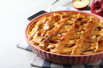 Traditional apple pie on light grey table, closeup