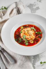 Salmon fish cake with tomato sauce and fresh greens