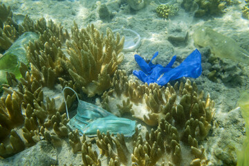 Face masks and plastic debris on bottom in Red Sea. Coronavirus COVID-19 is contributing to...
