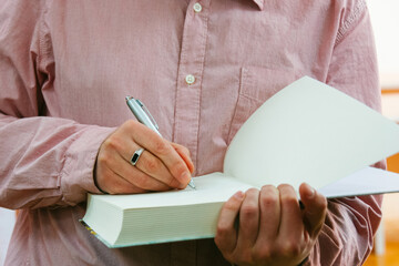 Man signing autograph