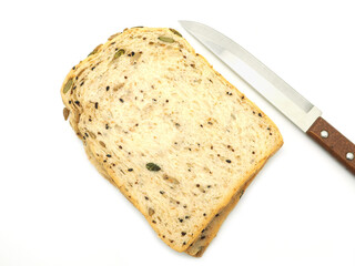 Fresh homemade slice of whole wheat bread  with knife isolated on a white background. Top view..