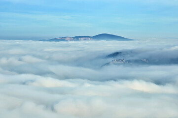 Panorama with a  foggy valley at Hungarian mountain range with sunlight. 