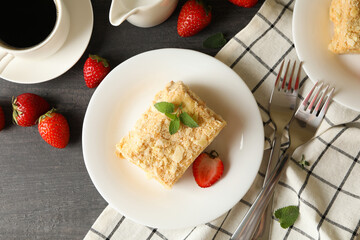 Concept of tasty lunch with Napoleon cake on gray wooden background