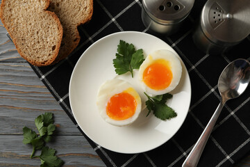 Concept of breakfast with boiled eggs on wooden background