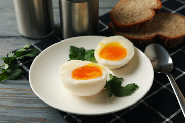 Concept of breakfast with boiled eggs on wooden background