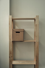 Fototapeta na wymiar Paper boxes are on a wooden rack. Archive storage, use of eco-friendly materials
