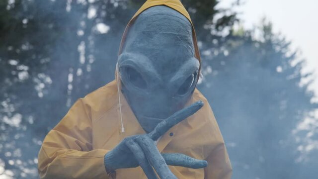 alien in yellow suit is dancing . close up. concept of UFO,space-themed costume party,