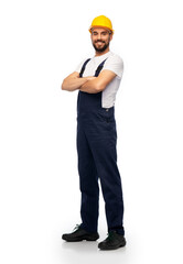 profession, construction and building - happy smiling male worker or builder in yellow helmet and...