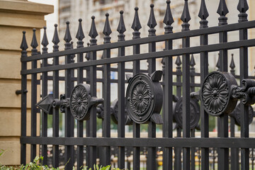 Forged decorative lattice. Antique fence with decorative elements. Close-up