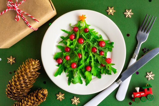 The Christmas tree salad on white plate on table. Flat lay