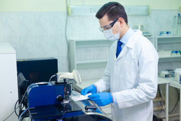 DNA laboratory. The expert puts the human DNA into the database using advanced laboratory technologies