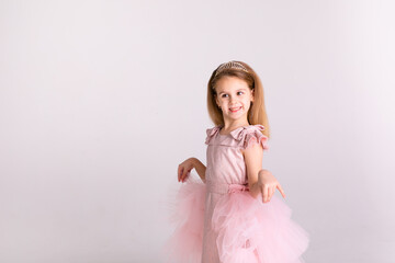 Beautiful little princess dancing in luxury pink dress