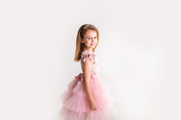 Beautiful little princess dancing in luxury pink dress