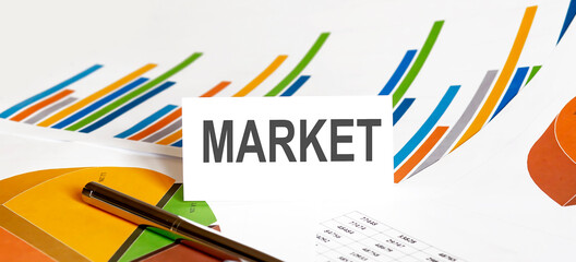 MARKET text on paper on chart background with pen