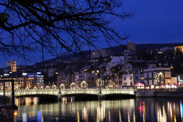Fototapeta na wymiar Zurich night on banks of Limmat river at Christmas season