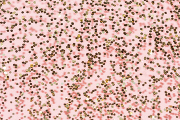 gold glitter with shadow layer on a pastel pink background