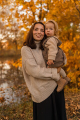 Fototapeta premium mother and child in autumn park