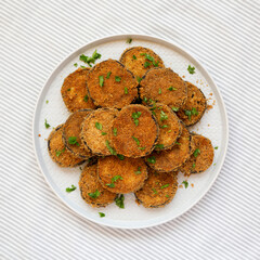 Homemade Garlic Parmesan Baked Eggplant on a plate, top view. Flat lay, overhead, from above.