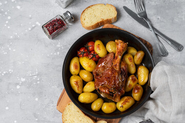 Homemade lunch roasted pork shank with potatoes. meat recipe