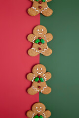 Creative Christmas layout made with gingerbread man on dual tone background. Minimal seasonal New Year or winter concept. Flat lay, top view.