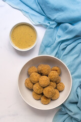 Lentil meatlball with curry sauce in a bowl