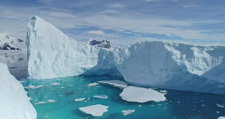 Tabular icebergs melting at rising sea aerial. Nobody nature, environment and landscapes of Antarctica ocean bay. Large ice fjord at blue arctic seascape. Affected by climate change and global warming