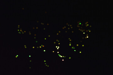 light yellow abstract pattern glitter stardust sparkling lights grunge on black.