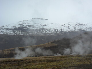 Hiking in the wild and dramatic landscapes of Iceland's snowy mountains, volcanoes, geysers, waterfalls and hot springs