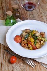 Japanese cuisine - udon udon with salmon, shrimp and vegetables. Garnished with cherry tomatoes.