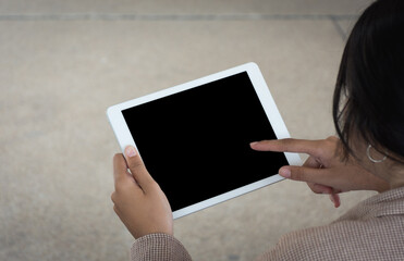 Woman worker using tablet computer at outdoor,soft focus.