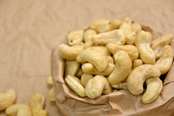 Cashew nuts. Cashew kernels. Clean organic nuts on retro paper background. Organic healthy food.