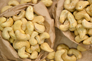 Cashew nuts. Cashew kernels. Clean organic nuts on retro paper background. Organic healthy food.