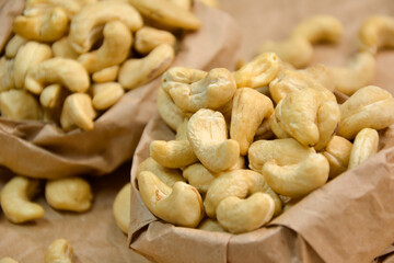 Cashew nuts. Cashew kernels. Clean organic nuts on retro paper background. Organic healthy food.