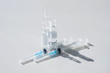 Vials with vaccine and syringes on the table