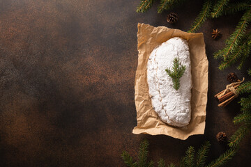 Christmas stollen - traditional German bread on brown. Holiday pastry dessert. Copy space.