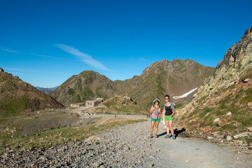 Obraz premium two hikers women in the path of Pyrenees mountains