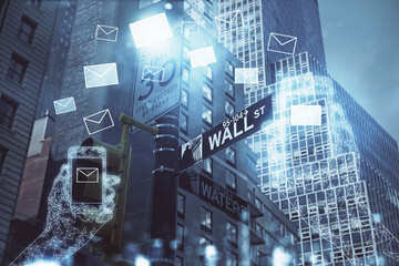Double exposure of envelop hologram flying from gadget and city view background. Concept e-mail.