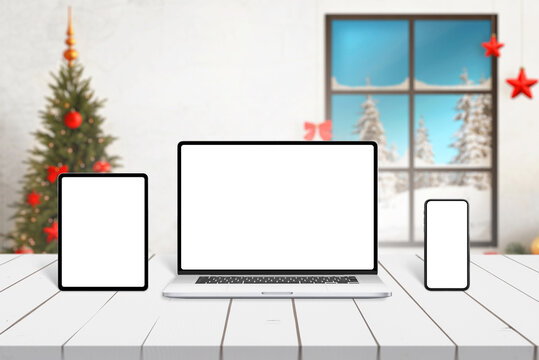 Laptop, tablet and smart phone mockup on white desk with Christmas decorations in background. Responsive design presentation template