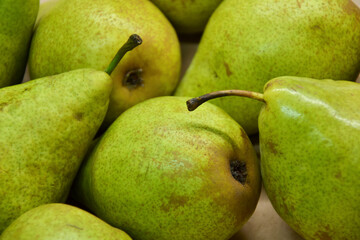 Pears background. Fresh pear fruit. Autumn fruits harvest on retro paper background. Organic farmers market products. Sweet, fresh and healthy food.