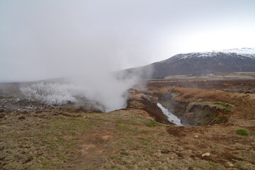 Hiking in the wild and dramatic nature of volanoes, snowy mountains, waterfalls, geysers and hot springs in Iceland