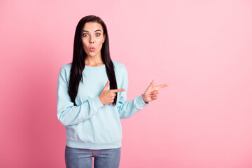 Photo of attractive shocked lady fingers direct empty space wear blue pullover jeans isolated pink color background