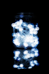 strip of Christmas lights closed inside a glass jar