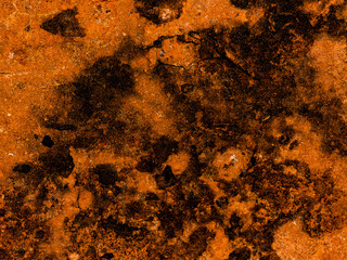 Abstract surface of cement ground, orange background with black stains