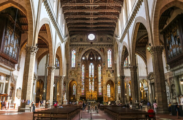 Fototapeta na wymiar Lovely view from the nave to the transept, chancel and apse with the main chapel inside the famous Basilica of Santa Croce in Florence, Tuscany, Italy.