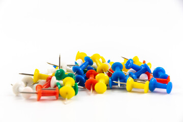 Many multicolored pins, macro photo on white isolated background