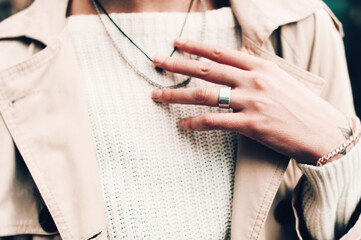 Close-up portrait Beautiful elegant woman wearing beige coat and black hat. Trendy casual outfit....