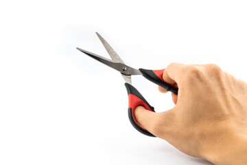 Man holding stationery scissors in hand, on white isolated background