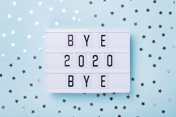 Lightbox with text BYE BYE 2020 on blue background. Top view. New year celebration. Happy New Year...