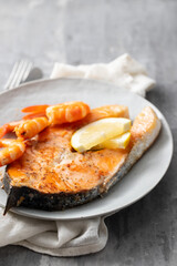 fried salmon with shrimps on white dish